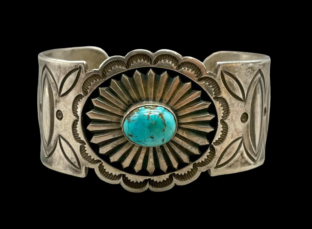 Vintage Turquoise And Sterling Silver Bracelet: For your bidding enjoyment we present a vintage turquoise and sterling silver bracelet. This bracelet features a lovely turquoise cabochon resting in a smooth silver bezel accented with scalloped edge