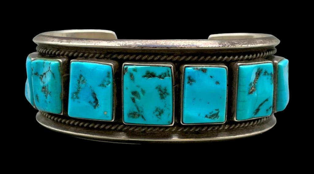 Vintage Eleven Square Stone Turquoise Bracelet: For your bidding enjoyment we present a vintage eleven square stone turquoise bracelet. This stunning bracelet features eleven square shaped turquoise cabochons resting in smooth silver bezels decorat