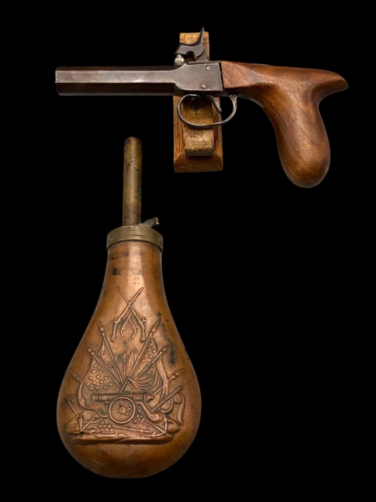 Black Powder Percussion Cap Pistol With Powder Horn: Offered here for your consideration is a black powder percussion cap pistol with a copper style powder horn. This old single shot percussion pistol has a wooden grip and octagonal barrel. The powder h