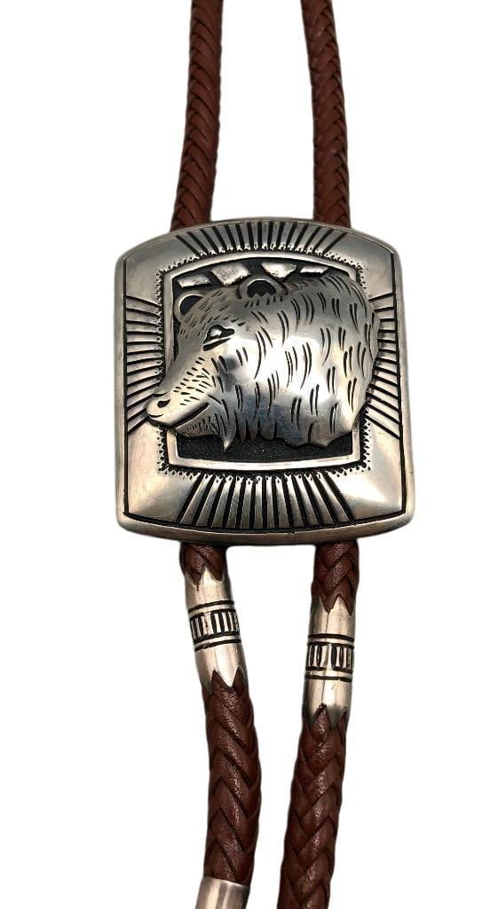Statement Tommy Singer Bear Themed Bolo Tie: Offered in this lot is a statement Tommy Singer bear themed bolo tie. This stunning bolo slide features a captivating central bear motif beautifully accented with hand stamped patterns and a darkened
