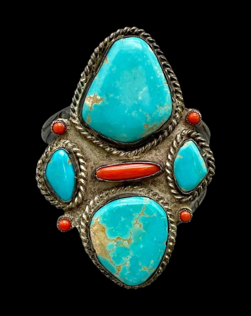 Vintage Turquoise And Coral Bracelet: For your bidding enjoyment we present a vintage turquoise and coral bracelet. This amazing bracelet features four turquoise cabochons and five coral cabochons displayed in smooth and sawtooth silver b