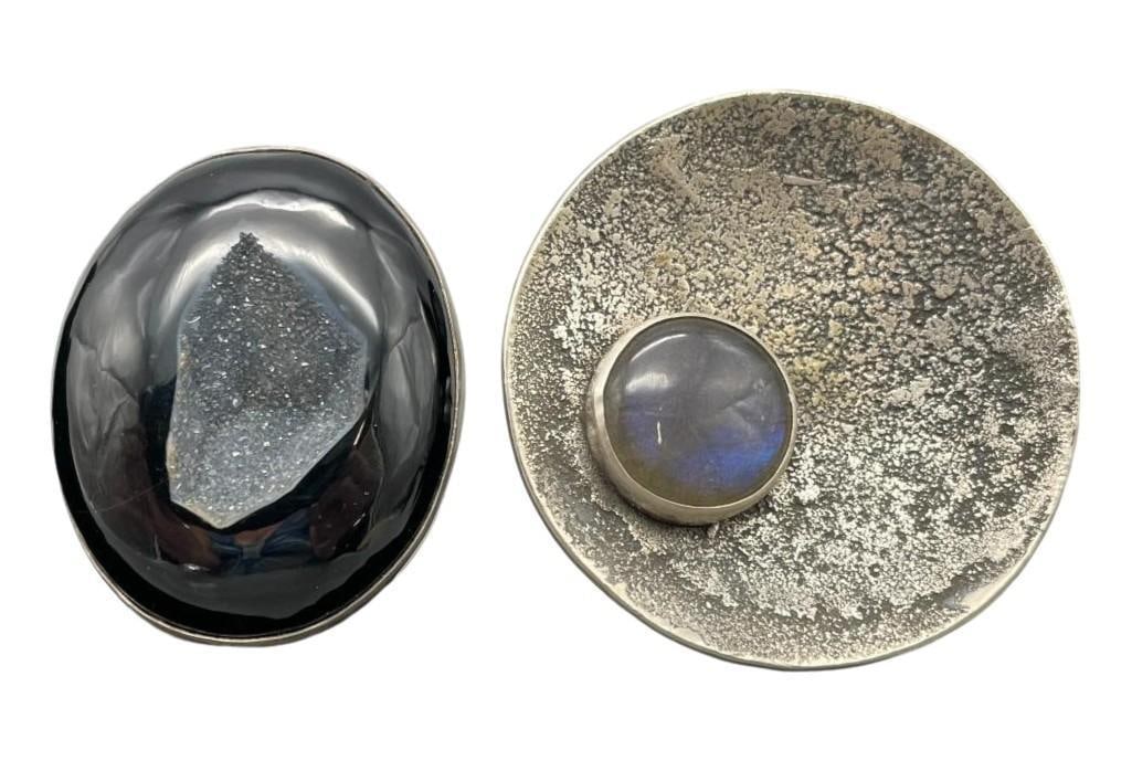 Two Unique Contemporary Rings By Nick Jackson: Offered here are two unique contemporary rings by Nick Jackson. The first ring showcases a gorgeous black druzy cabochon resting in a smooth silver bezel elegantly complemented by a classic smooth sil