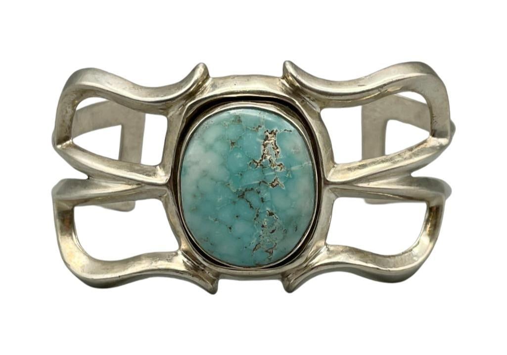 Sandcast And Turquoise Bracelet: For your bidding enjoyment we present a sandcast and turquoise bracelet. This beautiful bracelet features a lovely turquoise cabochon displayed in a smooth silver bezel arranged on a sandcast cuf