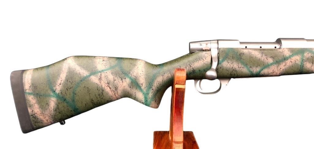 Weatherby Vanguard Bolt Action Rifle in .300 WSM: For your bidding pleasure is a Weatherby Vanguard bolt action rifle chambered in .300 WSM. The stock is a green and gray camo composite material with a rubber "limb saver" butt plate. The barrel, rece