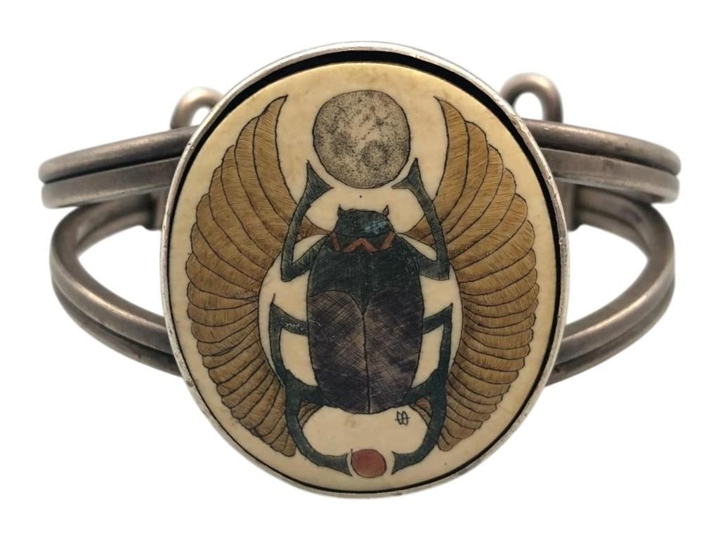 Handmade Ingot And Scrimshaw Ivory Bracelet: For your bidding enjoyment we present a handmade ingot and scrimshaw ivory bracelet. This bracelet showcases a central ivory cabochon highlighted with a scrimshaw design of an insect. The cabochon is 