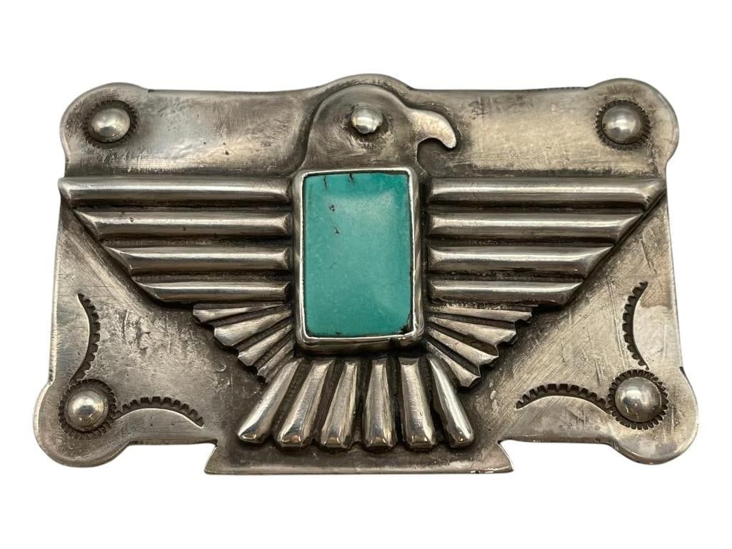 Ingot Thunderbird Turquoise Belt Buckle: Available here in this lot is an ingot Thunderbird turquoise belt buckle. This sterling silver belt buckle showcases a central rectangular turquoise cabochon displayed in a smooth silver bezel. The se