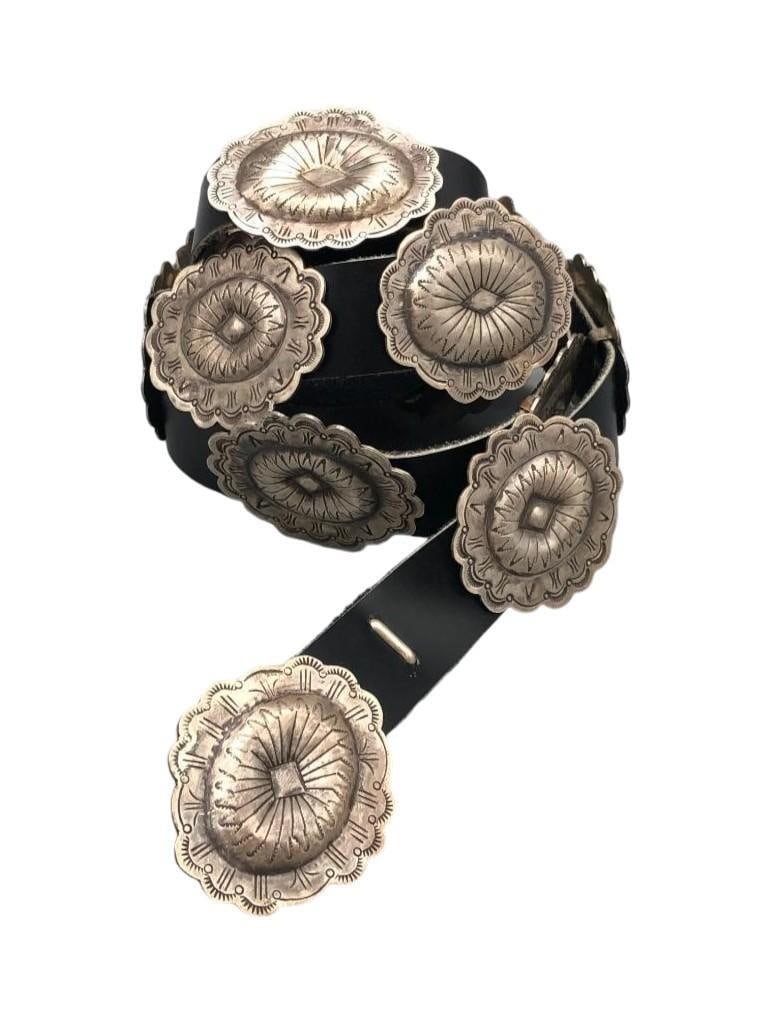 Sterling Silver Concho Belt With Fourteen Conchos And One Buckle: Offered here for your consideration is a sterling silver concho belt with fourteen conchos and one buckle. The belt has fourteen conchos and one buckle each with a beautiful round design accented with
