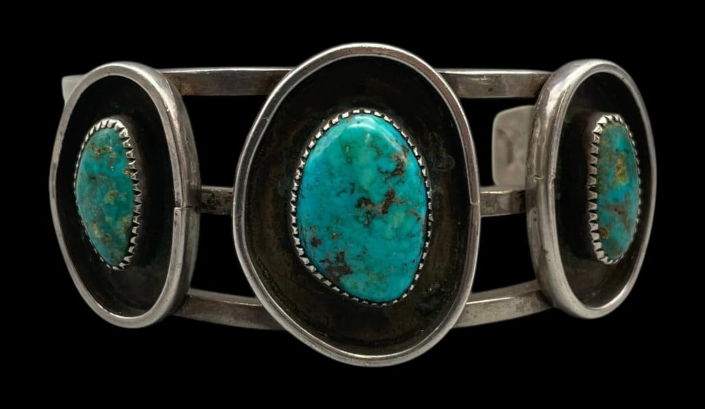 Three Stone Turquoise And Sterling Silver Bracelet: For your bidding enjoyment we present a three stone turquoise and sterling silver bracelet. This lovely bracelet features three turquoise cabochons resting in sawtooth silver bezels displayed in darke