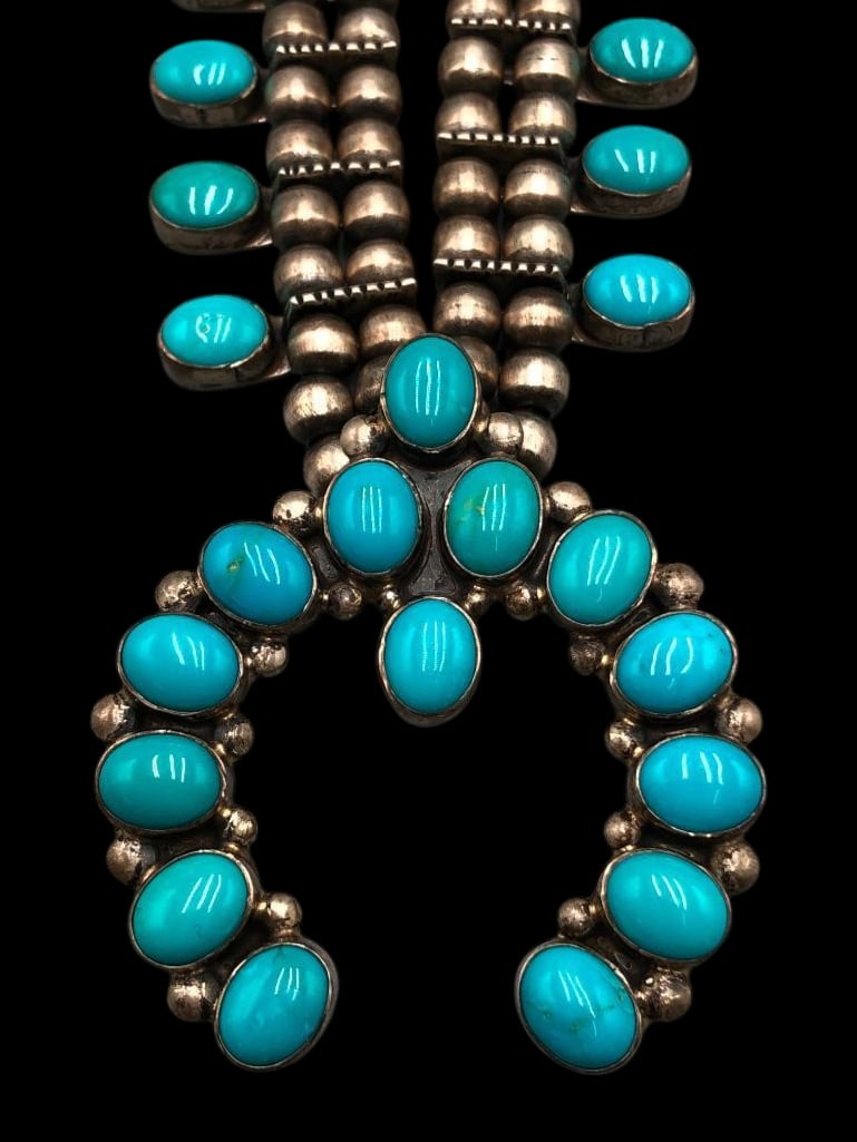 Sleeping Beauty Turquoise Squash Blossom Necklace By Don Lucas: Offered here for your consideration is a Sleeping Beauty turquoise squash blossom necklace by Don Lucas. This gorgeous necklace features a naja highlighted with 14 lovely Sleeping Beauty turquoise cab