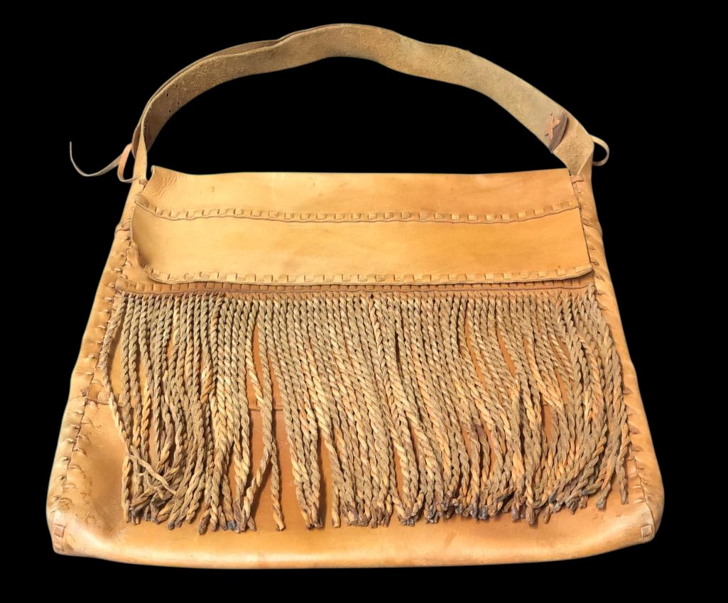 Large Fringed Leather Shoulder Bag: Offered here for your consideration is a large fringed leather shoulder bag. This nice brown leather bag features an inside small pocket, fold-over flap closure and long fringe on the front. The adjus