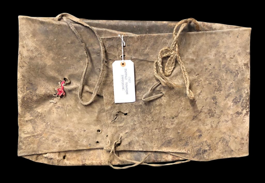 Circa Late 1800s Buffalo Hide Parfleche Bag: Offered here for your consideration is a circa late 1800s buffalo hide Parfleche bag. This large bag is very heavy leather and features multiple folds and tie closures, typical of this type of bag. It