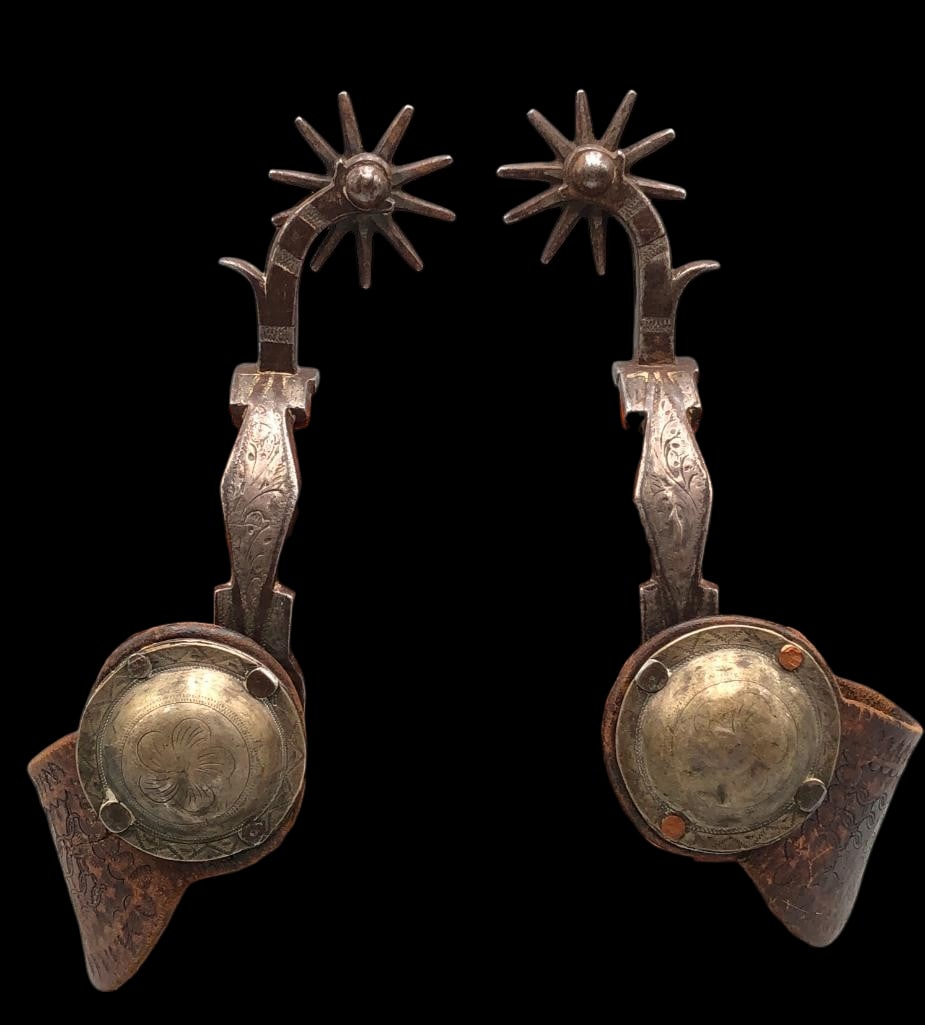 Silver Mounted And Chased California Style Spurs With Straps: Available here for your consideration are a pair of silver mounted and chased, California style spurs, with spur straps that have large conchos. They have chap guards and drop shanks with 10 point han