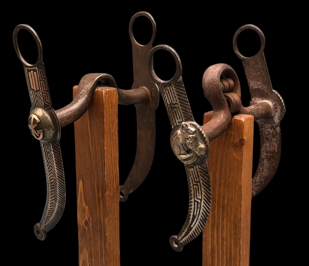 Two Nice Antique Mexican Bits: Available here for your consideration are two nice antique Mexican bits. One apparently has gold accents (not tested by us as to content) and the other has a horse head design. Both feature silver inl