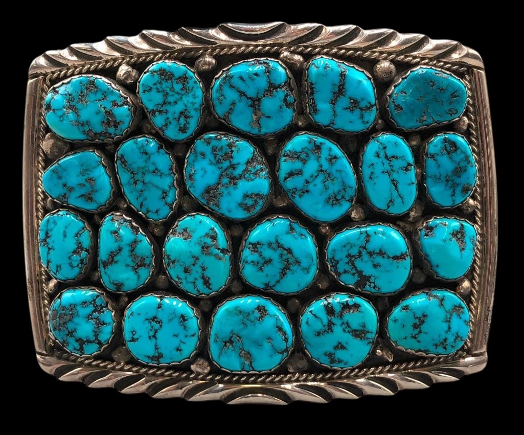 Turquoise And Sterling Silver Belt Buckle By Spencer: Available here in this lot is a turquoise and sterling silver belt buckle by Spencer. This sterling silver belt buckle features 22 turquoise cabochons resting in scalloped silver bezels beautifully ac
