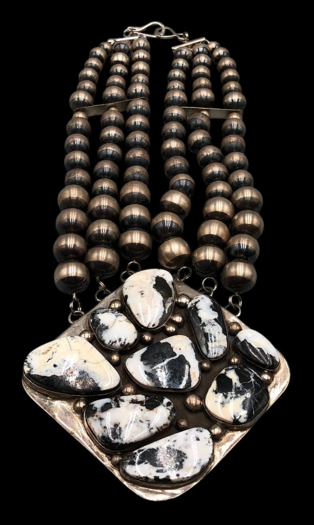 White Buffalo And Sterling Silver Necklace: Offered here for your consideration is a White Buffalo and sterling silver necklace. This great necklace showcases a pendant highlighted with nine White Buffalo cabochons each resting in smooth silver