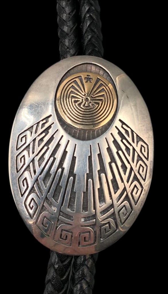 Sterling Silver And 14K Gold Bolo Tie By Jason Takala: Offered in this lot is a sterling silver and 14K gold bolo tie by Jason Takala. This striking bolo tie features a 14K gold Man in the Maze overlay design set against an etched and darkened silver back