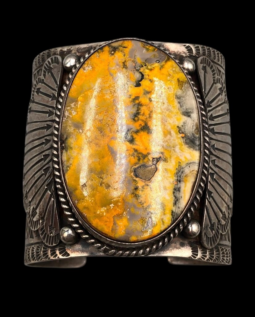 Yellow Jasper And Sterling Silver Bracelet: For your bidding enjoyment we present a yellow jasper and sterling silver bracelet. This bracelet features a striking yellow jasper cabochon resting in a smooth silver bezel surrounded by a twisted wi
