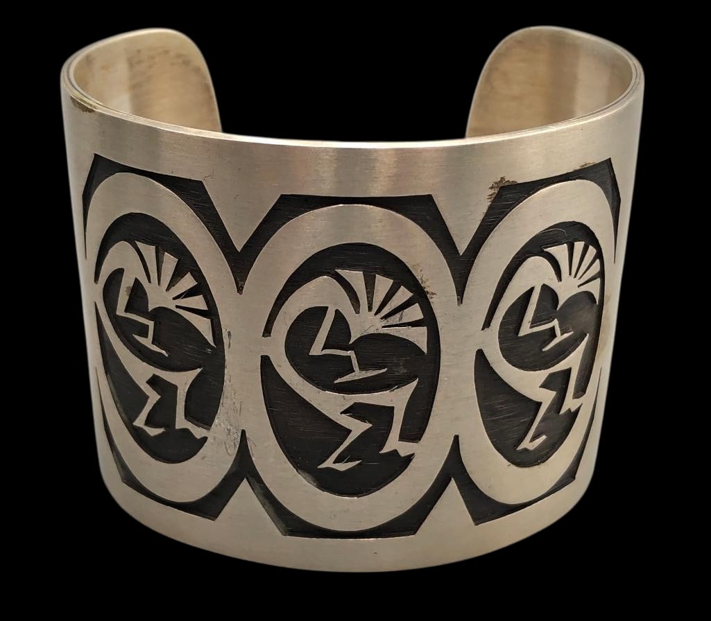Kokopelli Sterling Silver Overlay Bracelet: For your bidding pleasure is a Kokopelli sterling silver overlay bracelet. This bracelet features a Kokopelli themed overlay design with near perfect cutouts and lines set on a sterling silver cuff. T