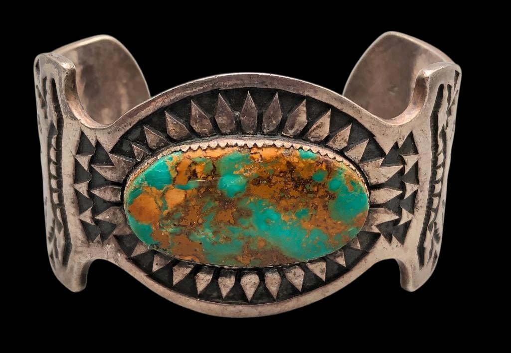 Turquoise And Sterling Silver Bracelet By Michael Tahe: For your bidding enjoyment we present a turquoise and sterling silver bracelet by Michael Tahe. This bracelet showcases a beautiful turquoise cabochon resting in a sawtooth silver bezel. The setting i