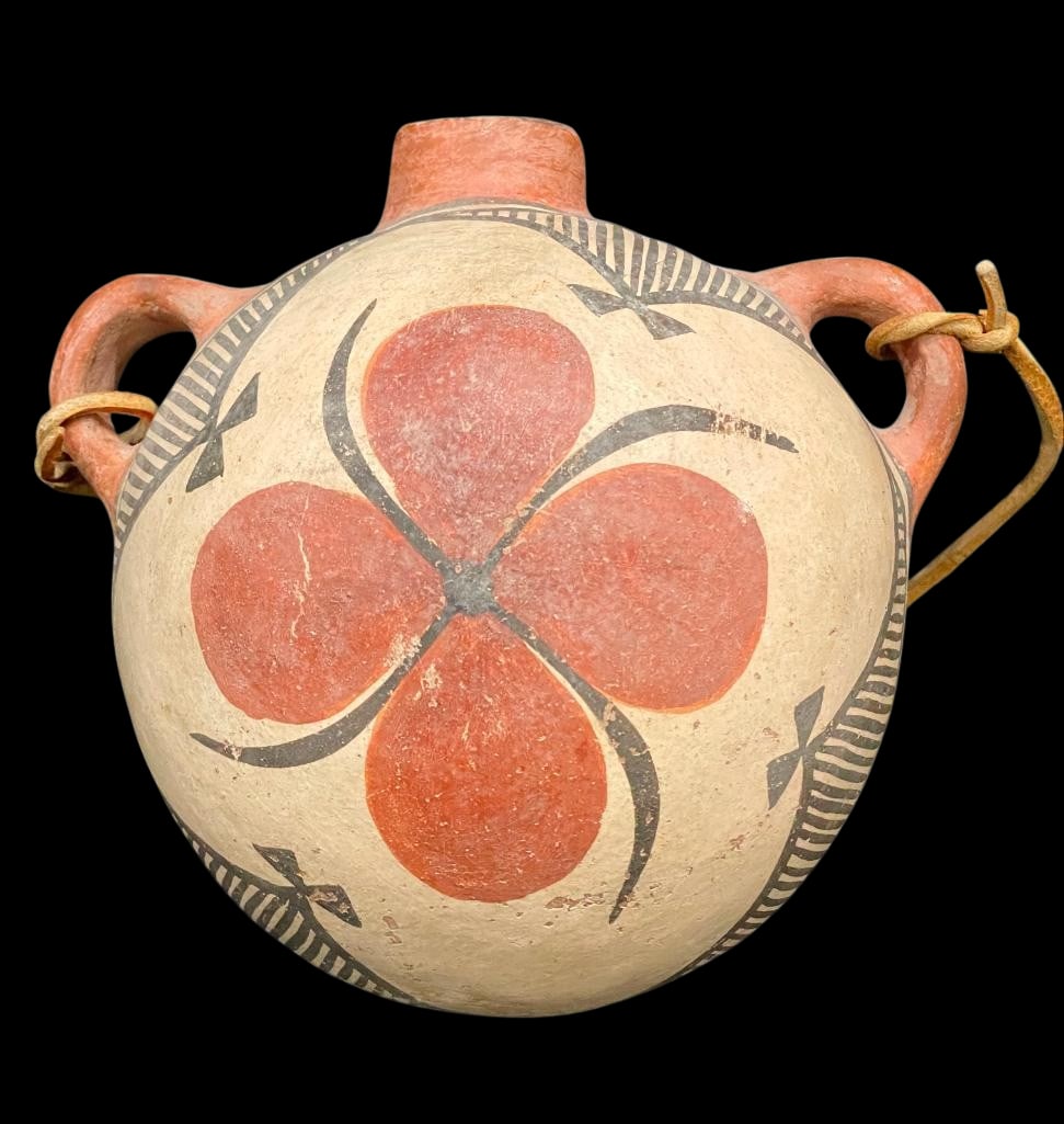 Old Pueblo Water Canteen: Presented here for your consideration is an old Pueblo water canteen. This canteen features orange slip nicely decorated with a flower design surrounded by a striped border with bows which has been we
