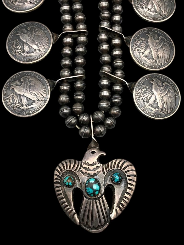 Turquoise Thunderbird And Coin Themed Squash Blossom Style Necklace: Offered here for your consideration is a turquoise Thunderbird and coin themed squash blossom style necklace. This striking necklace features a central pendant highlighted with a Thunderbird themed de