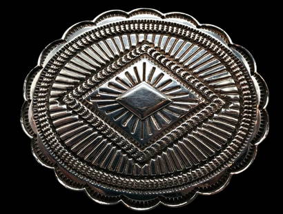 Sterling Silver Belt Buckle By Sunshine Reeves: Available here in this lot is a sterling silver belt buckle by Sunshine Reeves. This sterling silver belt buckle features a raised central diamond motif surrounded deeply hand stamped patterns and sca