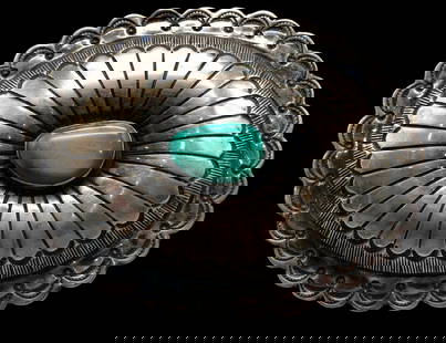1980s Concho Style Turquoise And Sterling Silver Belt Buckle: Available here in this lot is a 1980s concho style turquoise and sterling silver belt buckle. This great sterling silver belt buckle features a concho design highlighted with a central turquoise caboc