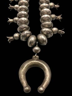 Hefty Statement  Handmade Four Petal Ingot Coin Silver Squash Blossom Necklace: Offered here for your consideration is a hefty statement handmade four petal ingot coin silver squash blossom necklace. This stunning necklace showcases an ingot silver naja complemented by 10 tab sty