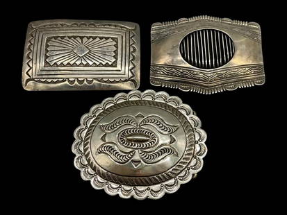 Three Sterling Silver Buckles: Offered here for your consideration are three sterling silver belt buckles. These finely crafted buckles have deep hand stamped designs, repousse elements and scalloped edges. One buckle features a ve