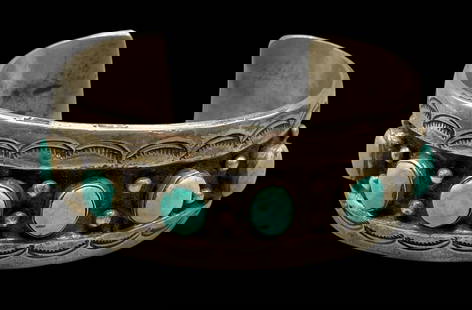 Six Stone Turquoise And Ingot Bracelet: Presented here is a six stone turquoise and ingot bracelet. This bracelet features six turquoise cabochons resting in smooth silver bezels. The settings are displayed on a sterling silver ingot cuff a