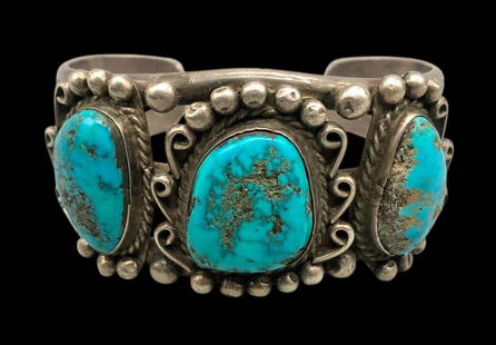 Hefty Vintage Three Stone Turquoise Bracelet: Offered here for your consideration is a hefty vintage three stone turquoise bracelet. This piece features three beautiful turquoise cabochons resting in smooth silver bezels surrounded by twisted wir