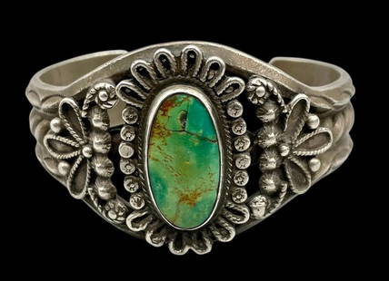 Hefty Vintage Turquoise And Sterling Silver Bracelet: Offered here for your consideration is a hefty vintage sterling silver bracelet featuring a large turquoise cabochon. This beautiful bracelet features a central turquoise cabochon resting in a smooth