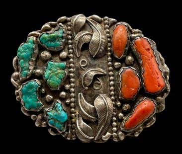 Vintage Turquoise And Coral Belt Buckle: Available here in this lot is a vintage turquoise and coral belt buckle. This sterling silver belt buckle features five turquoise nuggets and five branch coral setting all resting in handmade silver b