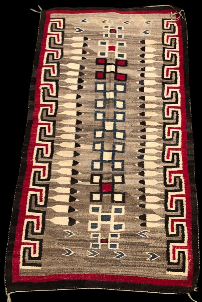 Vintage Pictorial Navajo Rug: Offered here is a vintage pictorial Navajo rug featuring a soft brown grey background highlighted with cream, red, blue and black. The center is highlighted with a column of stacked geometric squares 