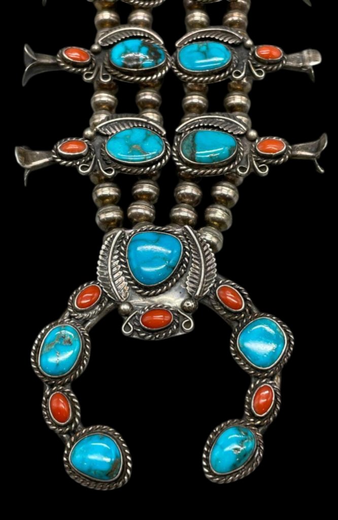 Vintage Turquoise and Coral Squash Blossom Necklace: Offered here for your consideration is a vintage turquoise and coral squash blossom necklace. Ten blossoms and a two wire naja showcase turquoise and coral cabochons displayed in smooth silver bezels.