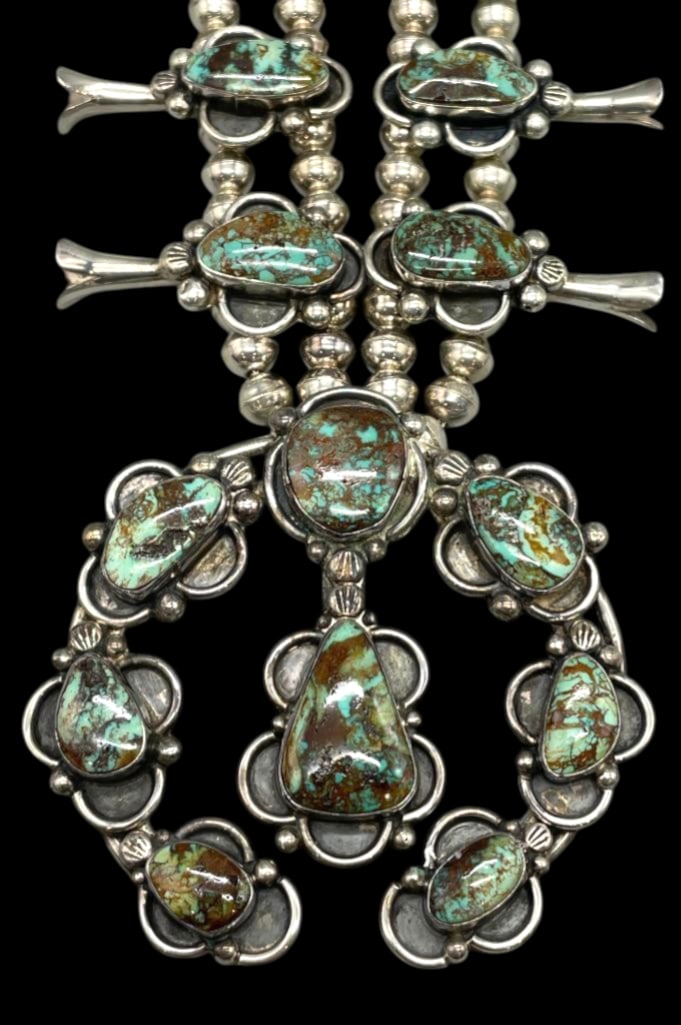 Eye Catching Turquoise and Sterling Silver Squash Blossom Necklace: For your bidding pleasure is an eye catching turquoise and sterling silver squash blossom necklace. The naja is highlighted with eight turquoise cabochons resting in smooth silver bezels surrounded by