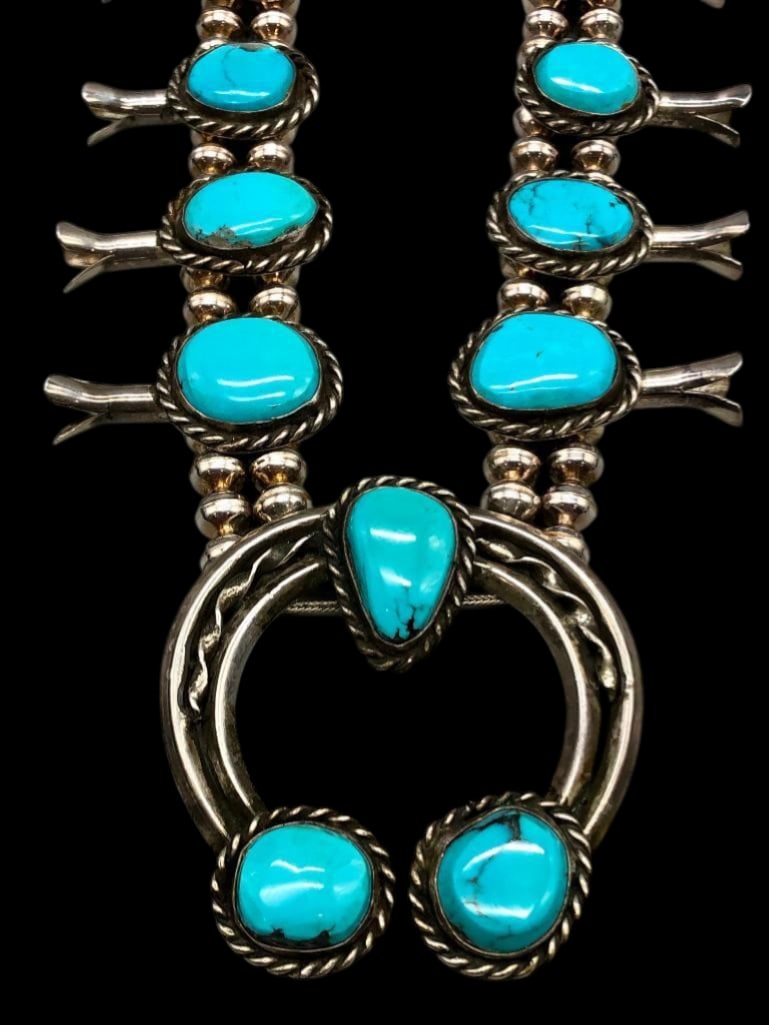 Vintage Turquoise Squash Blossom Necklace: Offered here for your consideration is a vintage turquoise and sterling silver squash blossom necklace. This necklace features a conjoined carinated two wire naja highlighted with three turquoise cabo