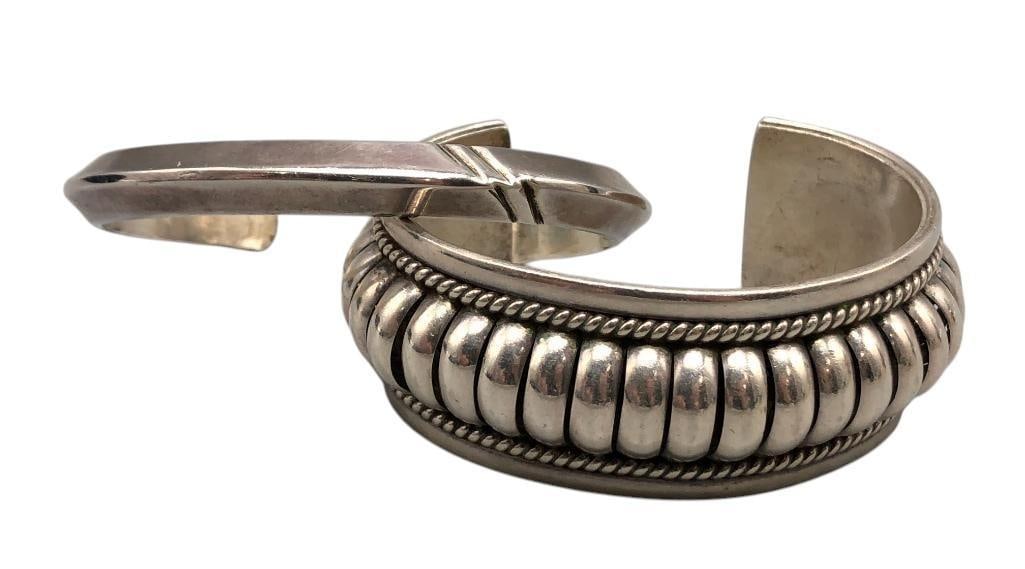 Two Sterling Silver Stylish Bracelets: For your bidding enjoyment we present two sterling silver stylish bracelets. One features a row of domed arches accented with twisted wire, while the other displays a smooth carinated silver form with