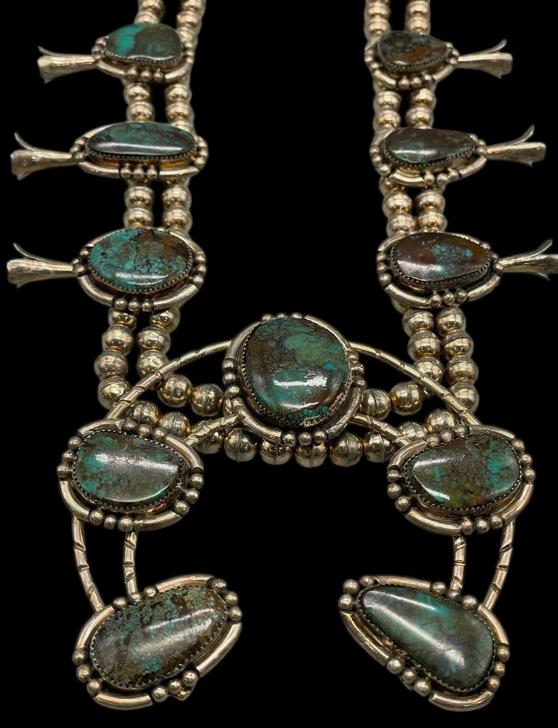 Substantial Nice Turquoise and Sterling Silver Squash Blossom Necklace: Offered here for your consideration is a substantial nice turquoise and sterling silver squash blossom necklace. This necklace features a double strand of sterling silver beads accented with twelve bl