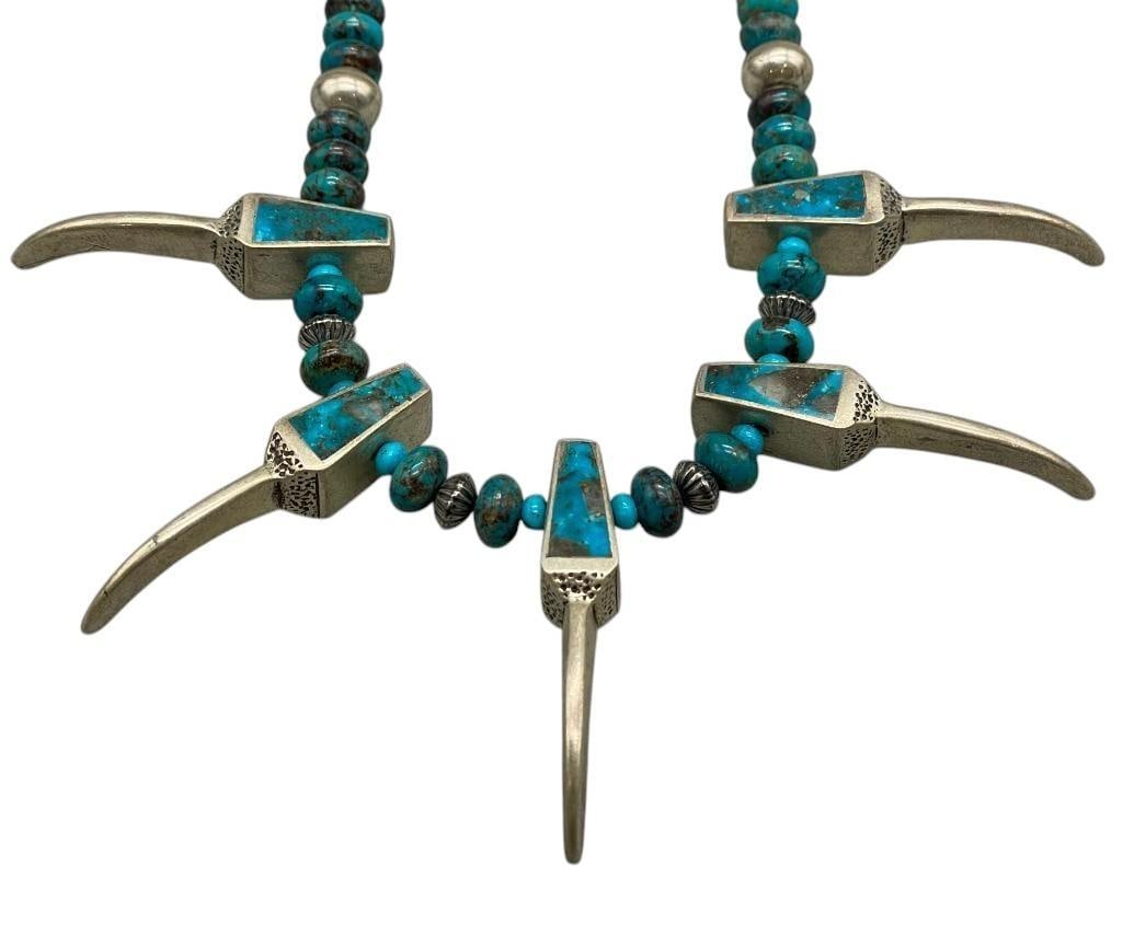 Claw Themed Turquoise and Sterling Silver Necklace: Offered here for your consideration is a claw themed turquoise and sterling silver necklace. This necklace features five turquoise and silver claw shaped pendants, strung between turquoise and sterlin