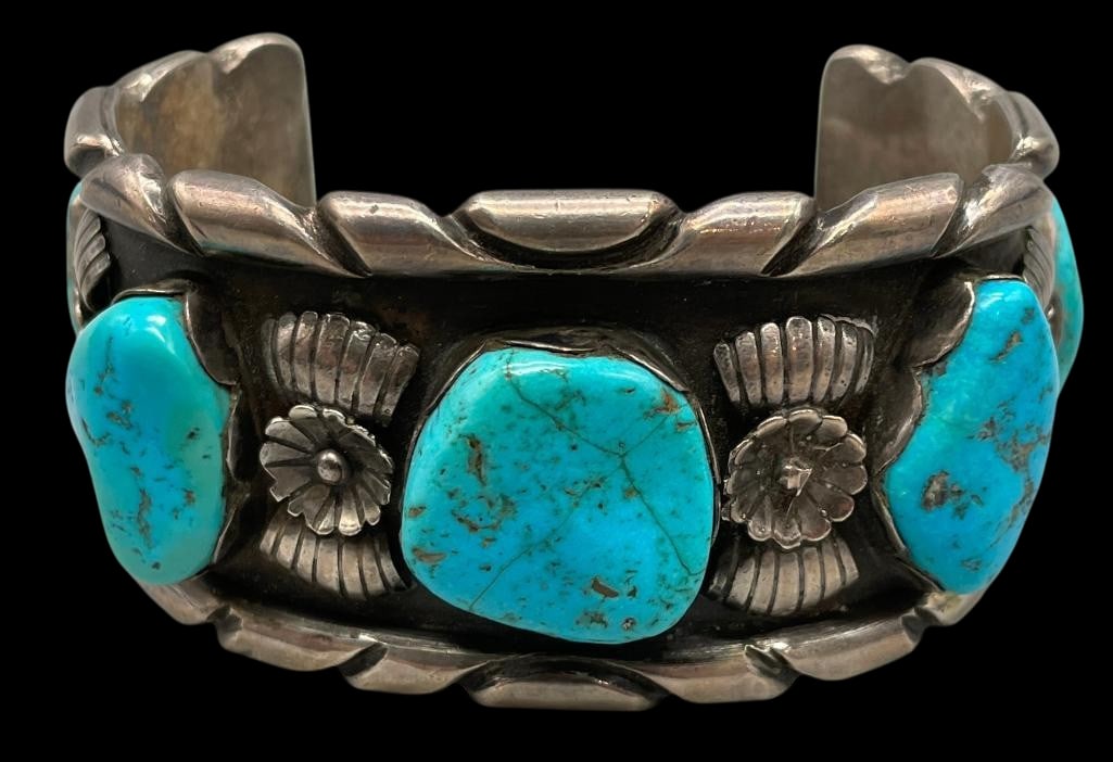 Hefty Five Stone Turquoise Bracelet: Offered here for your consideration is a hefty five stone turquoise and sterling silver bracelet. This bold cuff showcases five turquoise cabochons set in handmade scalloped bezels. Accenting the brac