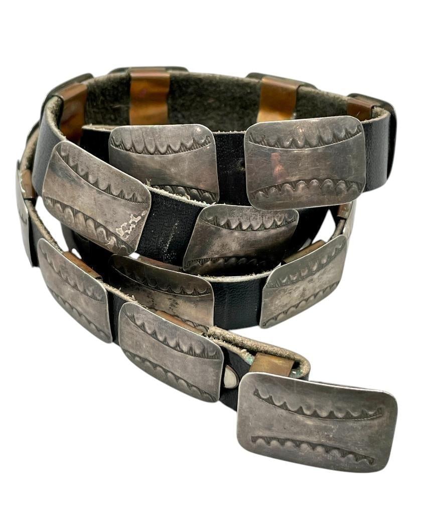 Small Size Sterling Silver Concho Belt / Hat Band: Offered here for your consideration is a small size sterling silver concho belt/ hat band. The belt has 22 rectangular conchos and a matching buckle each with stamped designs. The pieces are on a blac