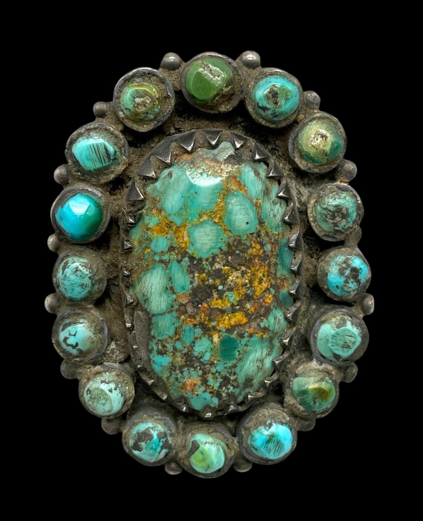 Handmade Turquoise Cluster Ring By Jock Favour: Offered here for your consideration is a handmade turquoise cluster ring by Jock Favour. The ring is highlighted by a larger central turquoise cabochon surrounded by a cluster of smaller turquoise cab