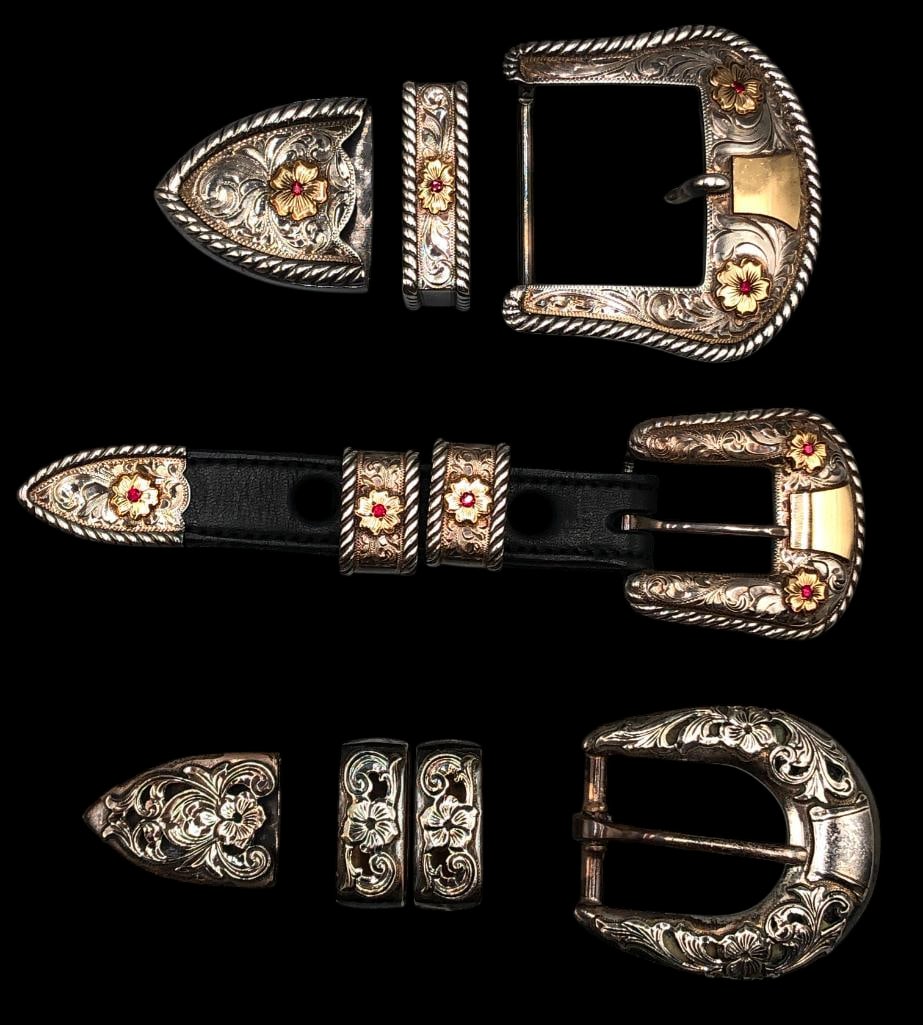 Three Elk Creek And Vogt Ranger Buckle Sets: Offered here for your consideration are three Elk Creek and Vogt Ranger buckle sets. Each set is crafted of sterling silver with hand engraved floral designs and 14k gold fill rosettes with red gemsto