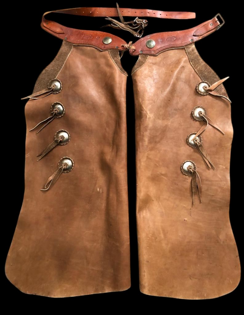 Batwing Chaps By Gila River Leather: Offered here for your consideration is a pair of batwing chaps by Gila River Leather of Phoenix, Arizona. These chaps feature Mexican coin conchos on the tooled leather waist band which is also stampe