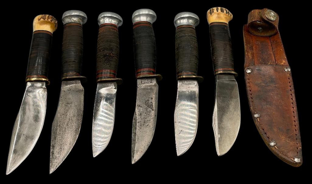Six Marbles Woodcraft Fixed Blade Knives: Offered here for your consideration is a group of six Marbles Woodcraft fixed blade knives. This grouping has stacked leather handles with aluminum pommels on four of them and stag pommels on the othe