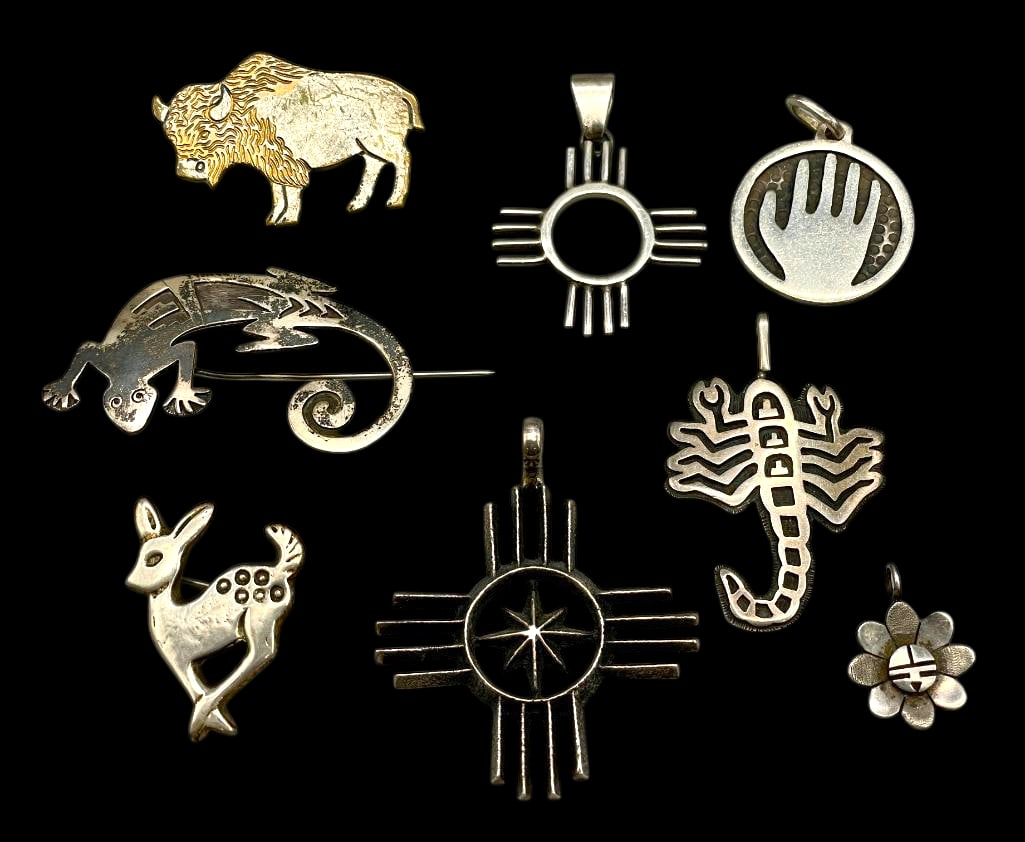Group Of Sterling Silver Pins And Pendants: Offered here for your consideration is a group of sterling silver pins and pendants. The designs include 3 animal pins (deer, bison and lizard) two Zia pendants, a Dawa pendant, a hand pendant, and a