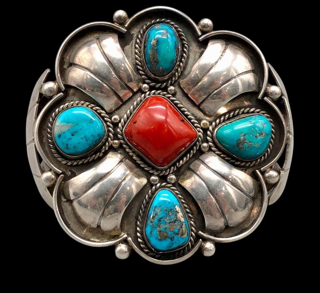 Vintage Turquoise And Coral Bracelet By Ben Johnson: Offered here for your consideration is a vintage turquoise, coral and sterling silver bracelet by Ben Johnson. The bracelet displays a central coral cabochon surrounded by turquoise cabochons, each se