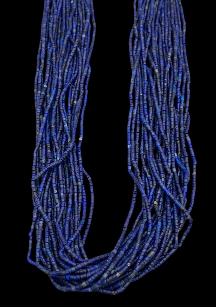 Fine 20 Strand Lapis Necklace: Offered here for your consideration is a fine 20 strand lapis necklace. The necklace features twenty strands of lapis Heishi beads strung on a waxed cord finished with gold filled tips and findings. T
