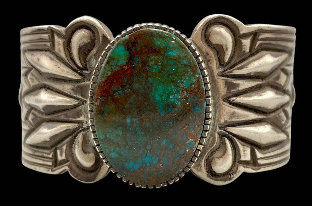 Phenomenal Hefty Turquoise And Sterling Silver Bracelet by Gibson Nez: For your bidding enjoyment we present a phenomenal hefty turquoise and sterling silver bracelet by multiple award winner Gibson Nez. This bracelet features an oval turquoise cabochon set in a serrated